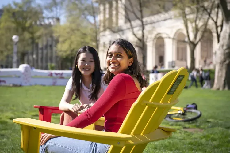 Students relax on campus between classes on a sunny day